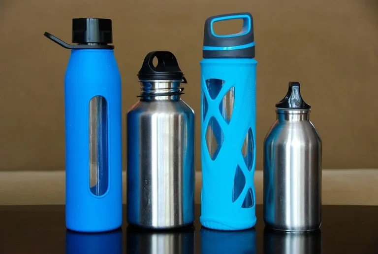 A row of colourful reusable water bottles - The Bottled Water Paradox, Explained in One Shopping Basket