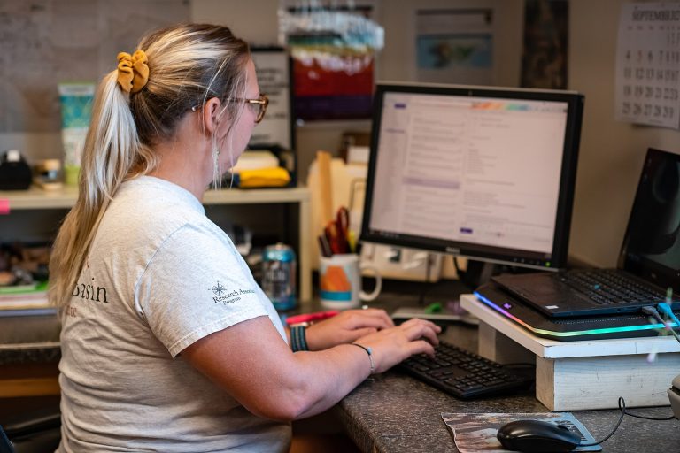 A person managing email on a laptop at a desk